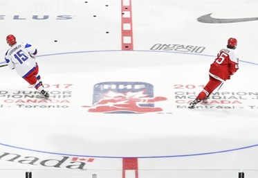 TORONTO, CANADA - JANUARY 2: Russia's Yegor Voronkov #15 and Denamark's Morten Jensen #15 skate through centre ice during warm ups prior to quarterfinal round action at the 2017 IIHF World Junior Championship. (Photo by Matt Zambonin/HHOF-IIHF Images)

